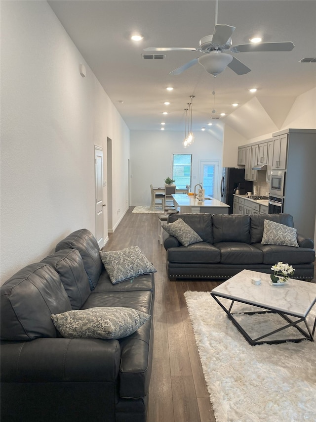 living room with dark hardwood / wood-style flooring, ceiling fan, lofted ceiling, and sink