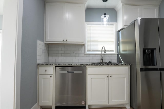 kitchen with tasteful backsplash, white cabinetry, appliances with stainless steel finishes, and sink