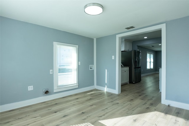 spare room with light wood-type flooring