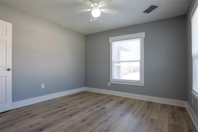 unfurnished room featuring ceiling fan, a textured ceiling, and light hardwood / wood-style floors