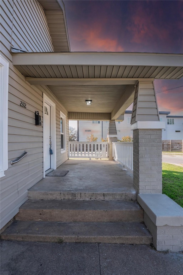 patio terrace at dusk with covered porch