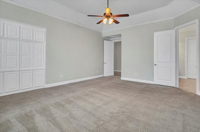 carpeted spare room with ceiling fan and crown molding