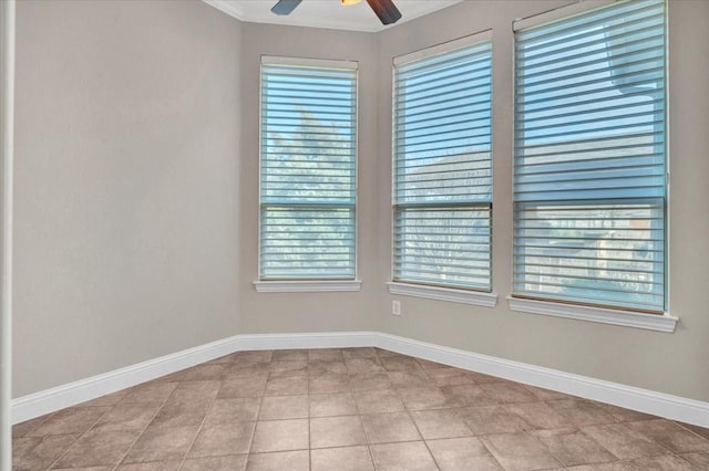 tiled empty room featuring ceiling fan and a wealth of natural light