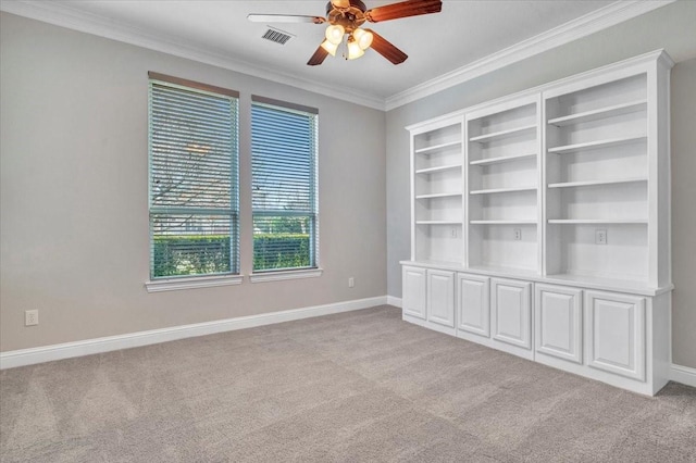 carpeted empty room featuring ceiling fan and ornamental molding