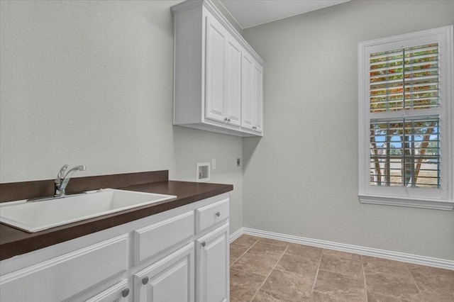 laundry room with sink, hookup for an electric dryer, hookup for a washing machine, and cabinets