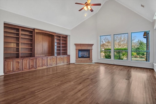 unfurnished living room with ceiling fan, dark hardwood / wood-style flooring, and high vaulted ceiling