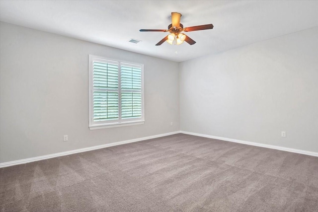 unfurnished room with ceiling fan and carpet