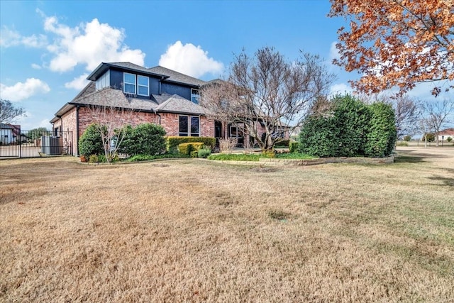 front facade with a front lawn and cooling unit