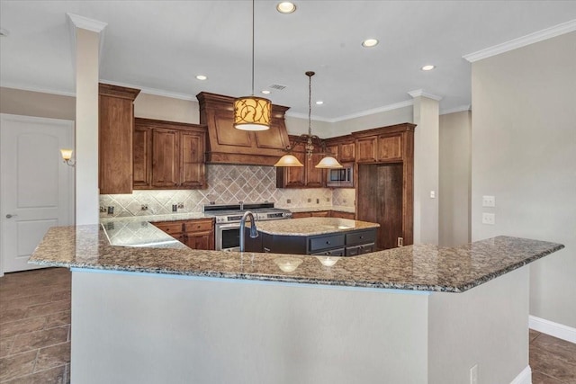 kitchen featuring backsplash, dark stone countertops, a kitchen island, hanging light fixtures, and custom range hood