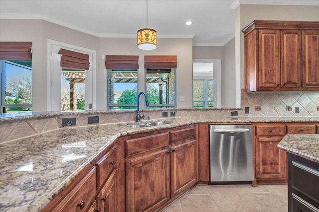 kitchen featuring tasteful backsplash, light stone countertops, ornamental molding, pendant lighting, and sink