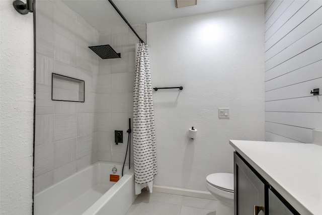 full bathroom featuring vanity, wooden walls, shower / bath combo with shower curtain, tile patterned flooring, and toilet