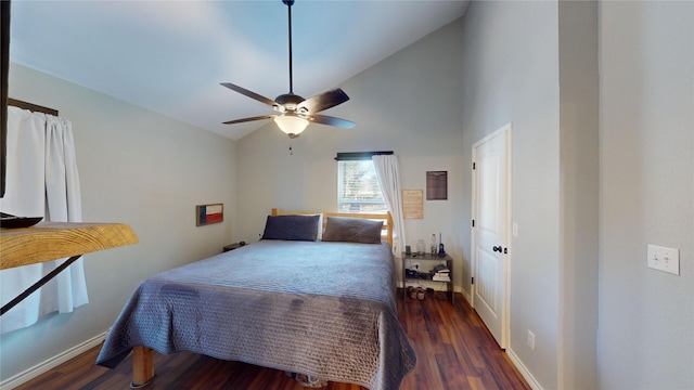 bedroom with ceiling fan, dark wood-type flooring, and high vaulted ceiling