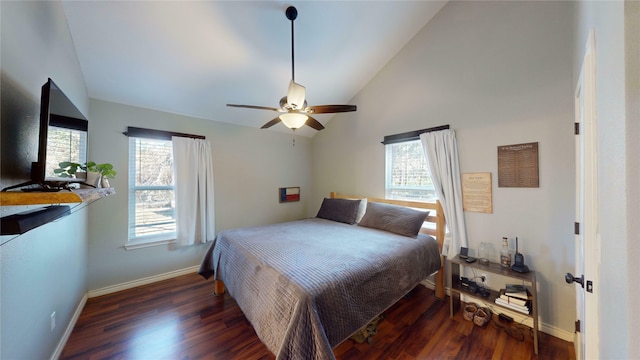 bedroom featuring ceiling fan, dark wood-type flooring, and lofted ceiling