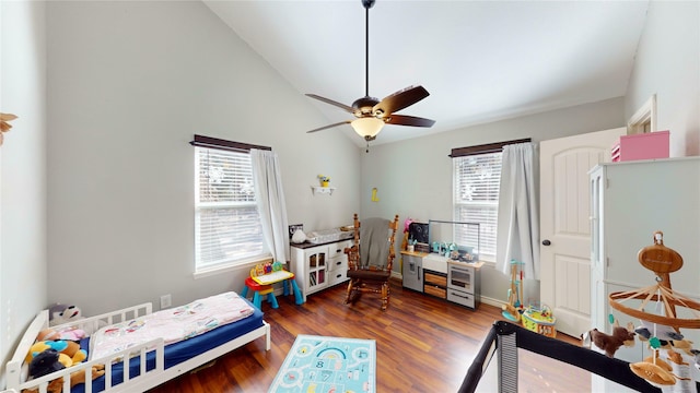 bedroom with vaulted ceiling, ceiling fan, dark hardwood / wood-style floors, and multiple windows