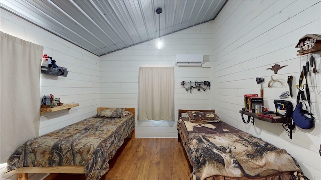 bedroom with a wall mounted AC, lofted ceiling, dark hardwood / wood-style flooring, and wooden walls