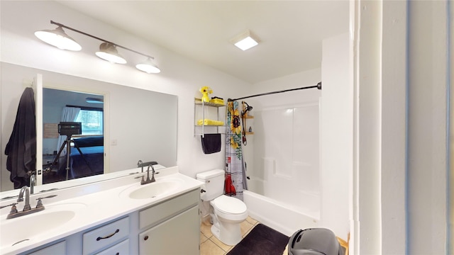 full bathroom featuring toilet, tile patterned floors, vanity, and shower / tub combo with curtain