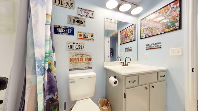 bathroom featuring toilet and vanity