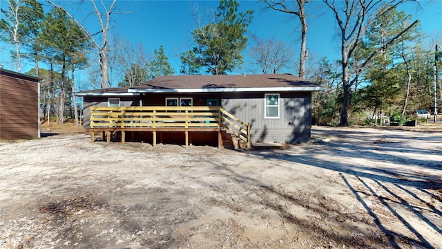 back of property featuring a wooden deck