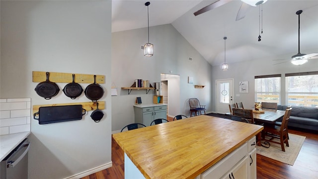 kitchen with ceiling fan, dark wood-type flooring, stainless steel dishwasher, and high vaulted ceiling