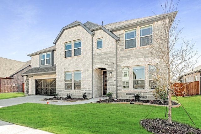 view of front of property featuring fence, concrete driveway, a front lawn, a garage, and brick siding