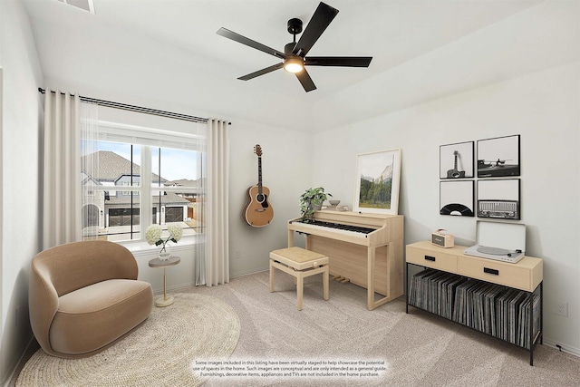 sitting room with baseboards, a ceiling fan, and carpet flooring