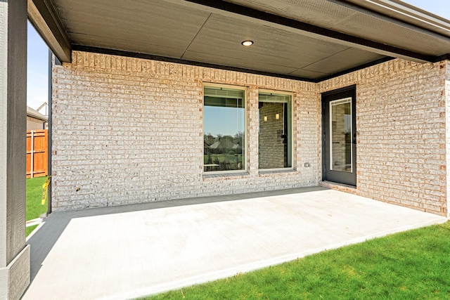 view of patio featuring visible vents and fence