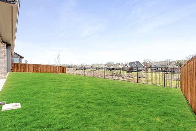 view of yard with a residential view and a fenced backyard