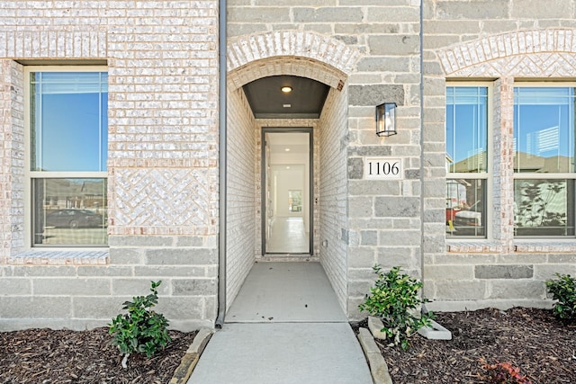 property entrance featuring stone siding