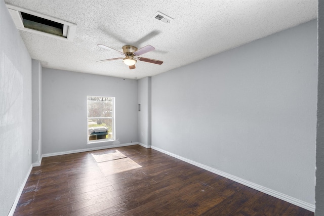 spare room with ceiling fan, a textured ceiling, and dark hardwood / wood-style flooring