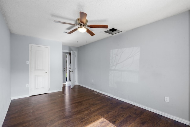 unfurnished room with ceiling fan, dark hardwood / wood-style flooring, and a textured ceiling