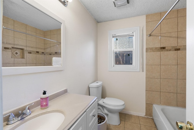 full bathroom with tile patterned floors, toilet, tiled shower / bath, a textured ceiling, and vanity