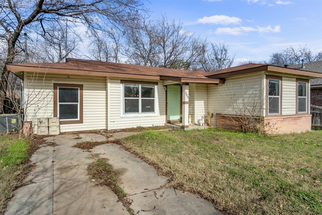 single story home featuring a front yard and central air condition unit