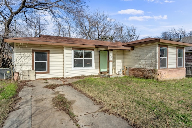 ranch-style home with central AC and a front lawn