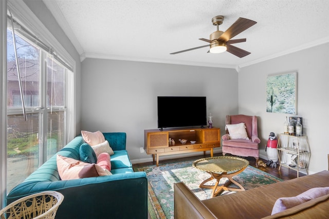 living room with a textured ceiling, ceiling fan, and crown molding