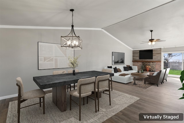 dining room featuring hardwood / wood-style flooring, ceiling fan with notable chandelier, crown molding, and vaulted ceiling