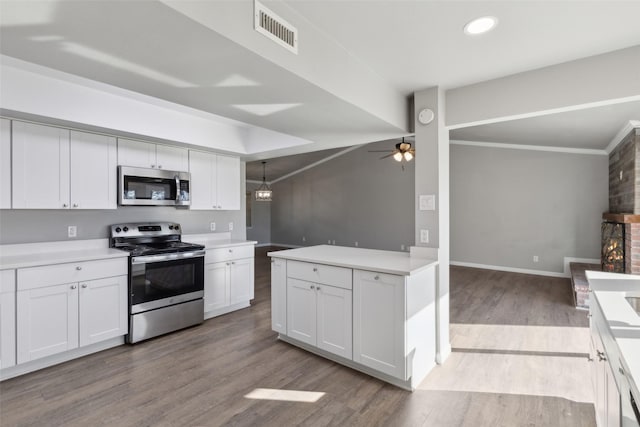 kitchen featuring pendant lighting, light hardwood / wood-style flooring, ceiling fan, white cabinetry, and stainless steel appliances