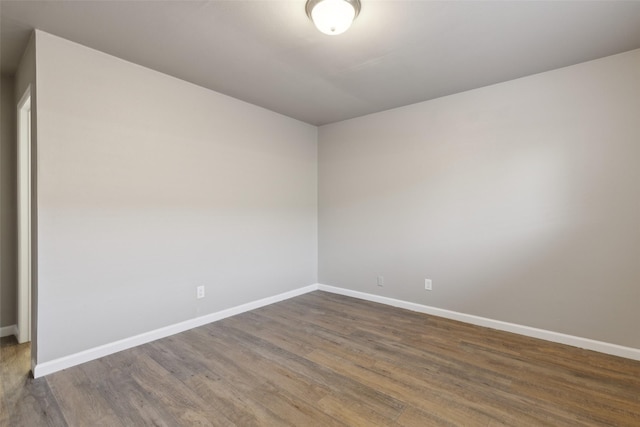 spare room with dark hardwood / wood-style flooring