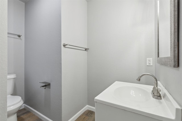 bathroom featuring vanity, hardwood / wood-style floors, and toilet