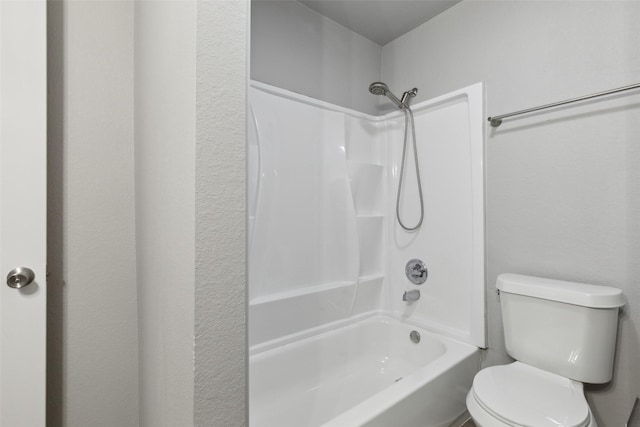 bathroom with shower / bathing tub combination and toilet