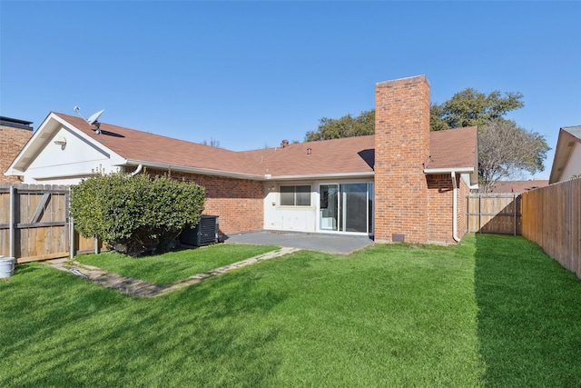 back of house featuring a lawn, central air condition unit, and a patio area