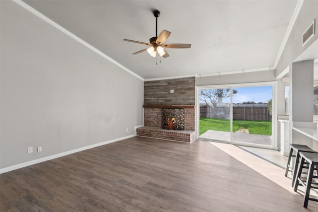 unfurnished living room with a fireplace, wood-type flooring, ceiling fan, and crown molding