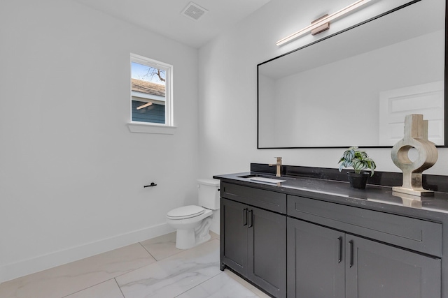 half bath featuring toilet, vanity, visible vents, baseboards, and marble finish floor