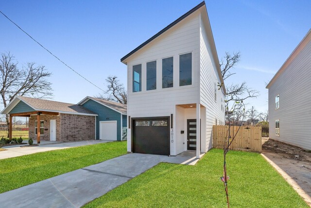 view of front of home with a garage and a front lawn