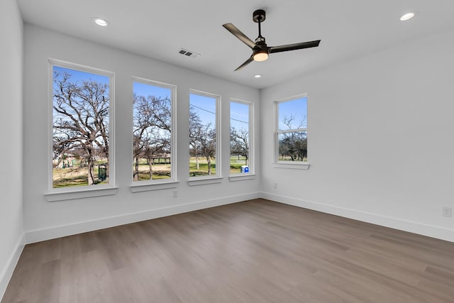 empty room with hardwood / wood-style flooring and ceiling fan