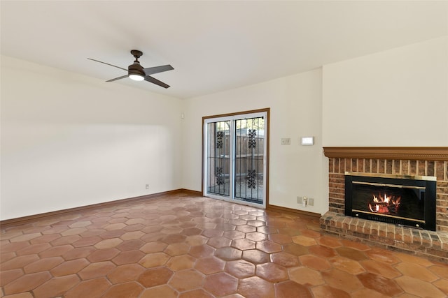 unfurnished living room featuring ceiling fan and a fireplace