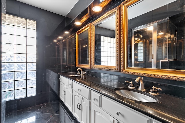 bathroom with vanity and tile walls