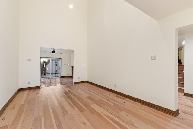 unfurnished living room with light wood-type flooring and ceiling fan