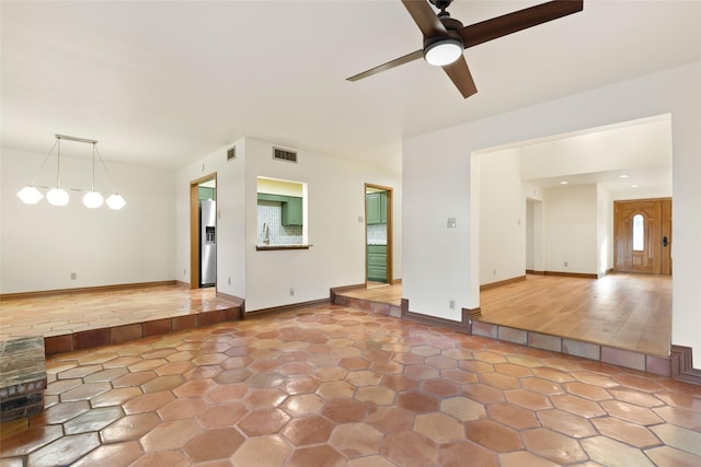 interior space with ceiling fan