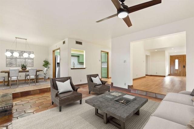 living room with light wood-type flooring and ceiling fan