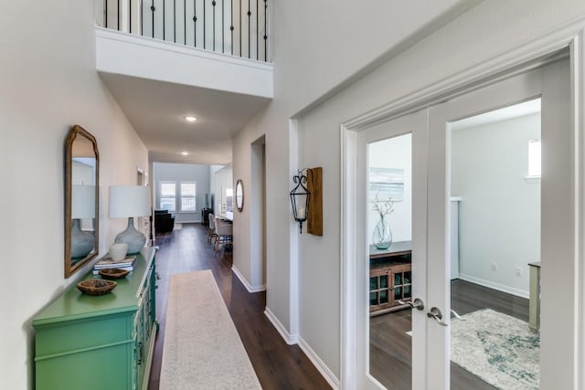 hallway featuring french doors and dark wood-type flooring